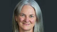 Woman with grey hair smiling at camera