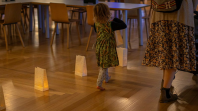 Child walking through a line of lanterns